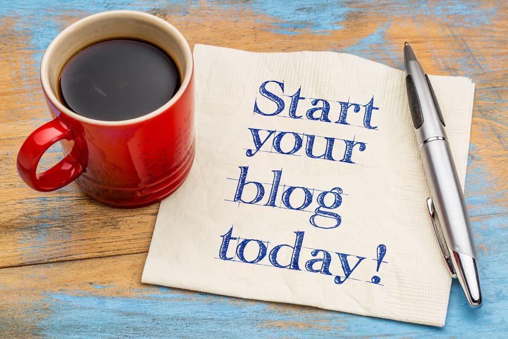 Start your blog today - handwriting on a napkin with a cup of espresso coffee